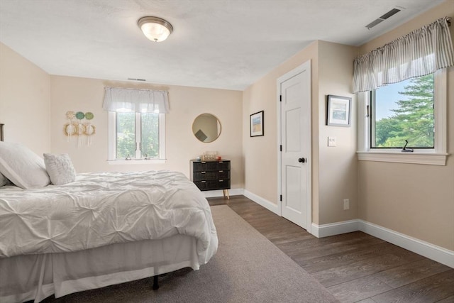 19 Buckmaster Dr, Sudbury, MA 01776 - bedroom with visible vents, baseboards, wood finished floors, and multiple windows