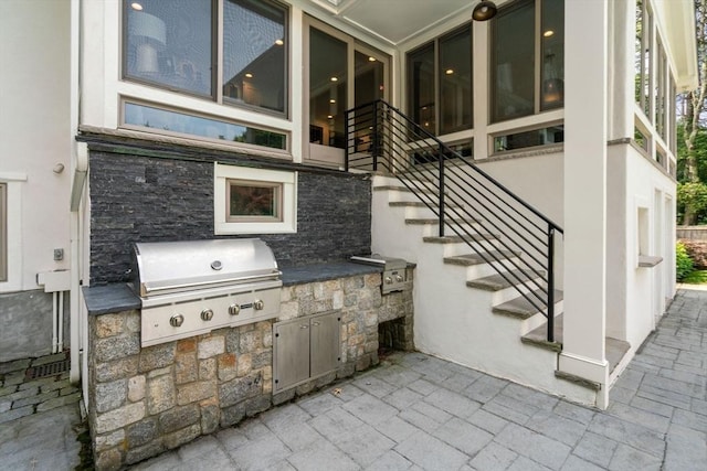 19 Buckmaster Dr, Sudbury, MA 01776 - view of patio featuring exterior kitchen, area for grilling, and stairway