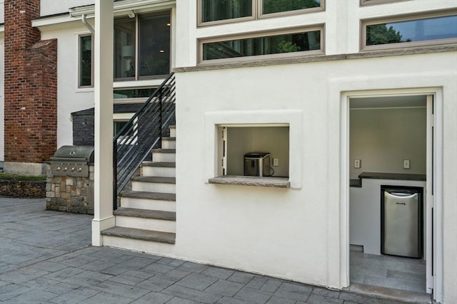 19 Buckmaster Dr, Sudbury, MA 01776 - property entrance featuring a patio and stucco siding