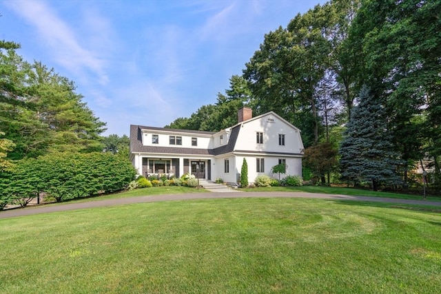 19 Buckmaster Dr, Sudbury, MA 01776 - view of front facade with a chimney, a front yard, and a gambrel roof