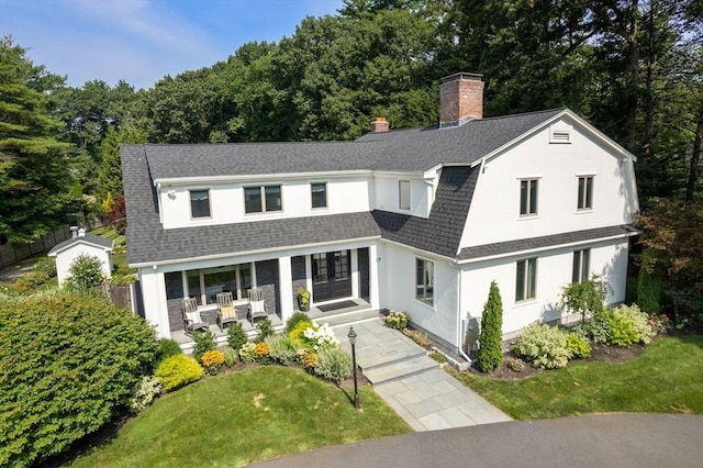 19 Buckmaster Dr, Sudbury, MA 01776 - view of front of property featuring french doors, a shingled roof, a chimney, and a front lawn