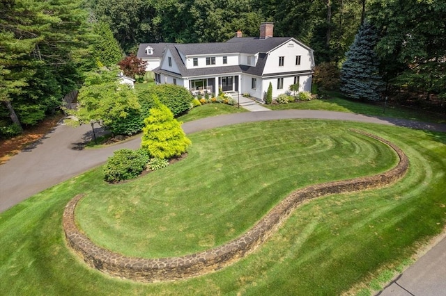 19 Buckmaster Dr, Sudbury, MA 01776 - view of front of house with curved driveway, a front lawn, a chimney, and a porch