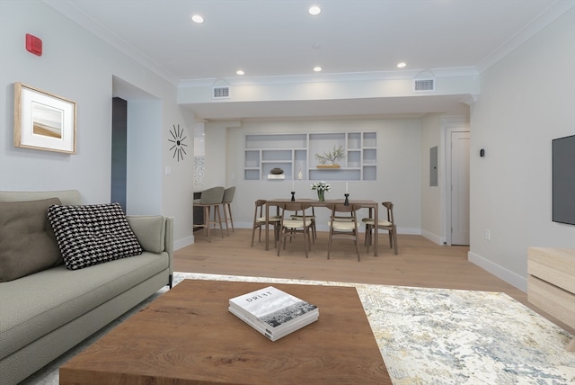 living room featuring electric panel, hardwood / wood-style flooring, and crown molding