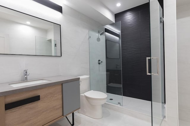 bathroom featuring toilet, a shower with shower door, tasteful backsplash, tile walls, and vanity