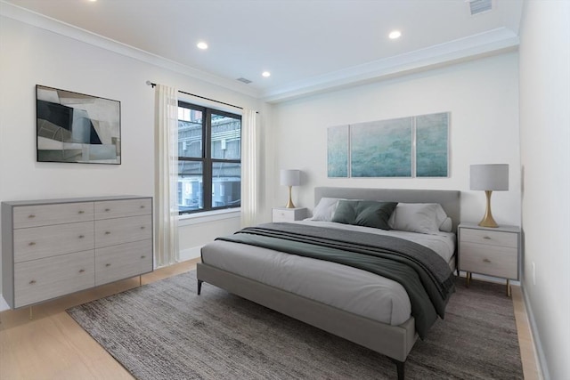 bedroom featuring wood-type flooring and crown molding