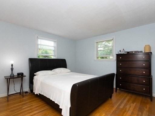 bedroom featuring wood finished floors and baseboards