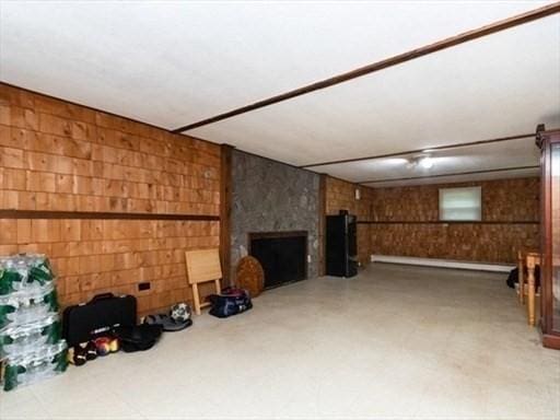 finished basement featuring a large fireplace