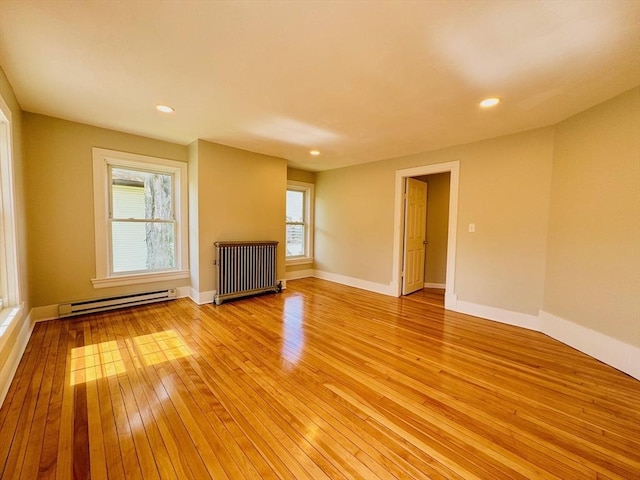 unfurnished room featuring light wood finished floors, recessed lighting, radiator heating unit, baseboard heating, and baseboards