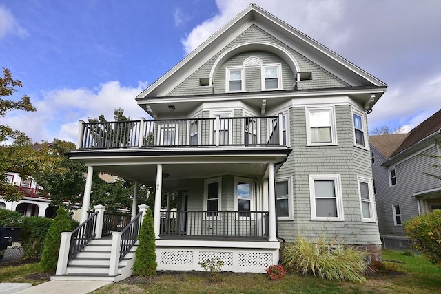 victorian home with a balcony and covered porch