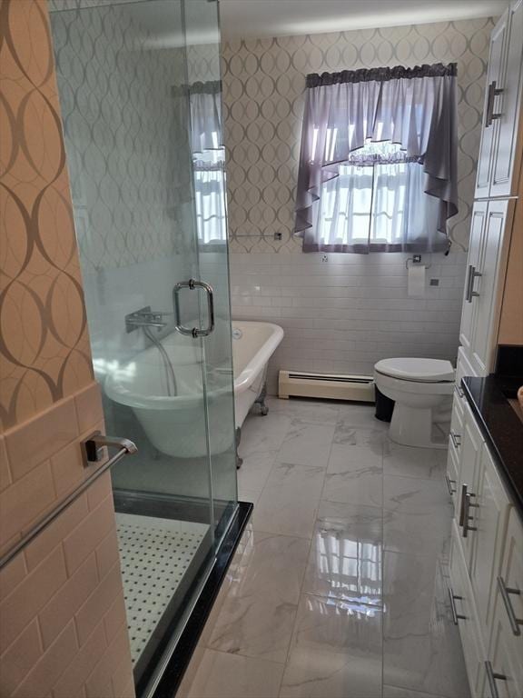 full bathroom featuring vanity, toilet, tile walls, independent shower and bath, and a baseboard radiator