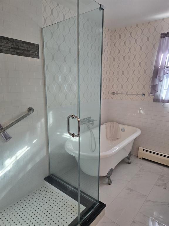 bathroom with shower with separate bathtub, tile walls, and a baseboard heating unit