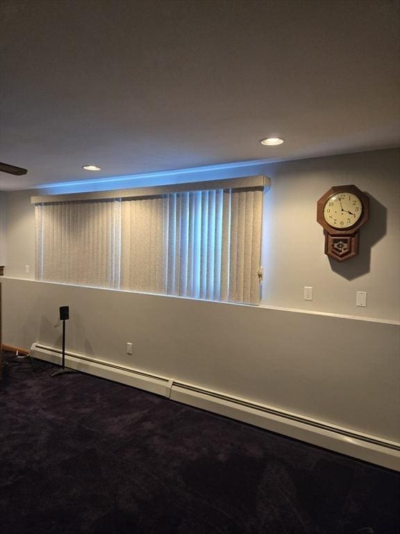 spare room with carpet floors and baseboard heating