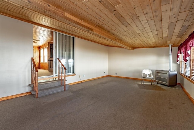 empty room featuring carpet, a healthy amount of sunlight, and wooden ceiling