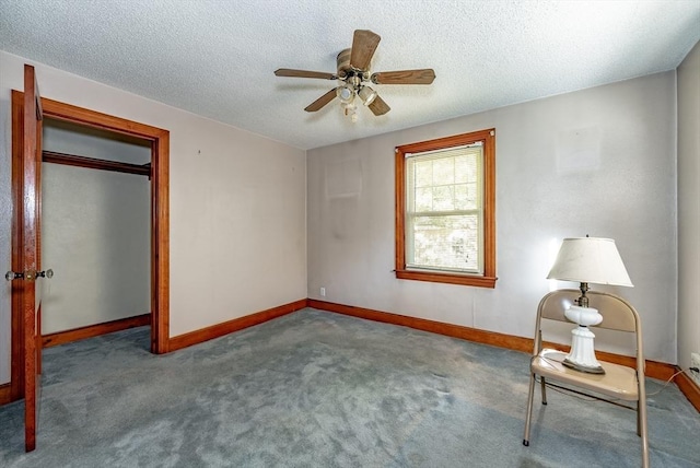 unfurnished room featuring carpet, ceiling fan, and a textured ceiling