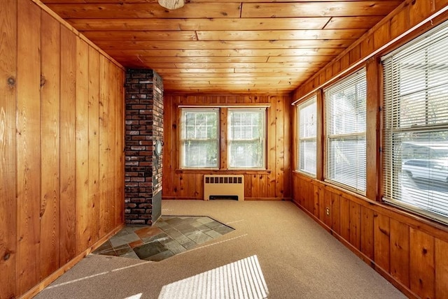 unfurnished sunroom with wood ceiling and radiator