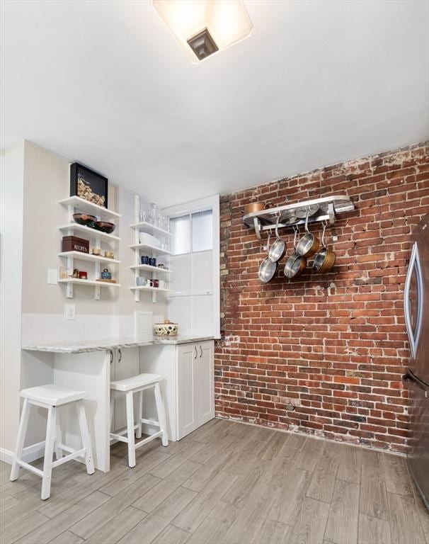 37 Grove St Unit 2, Boston, MA 02114 - bar featuring brick wall and light wood-type flooring
