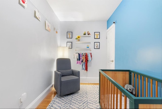 37 Grove St Unit 2, Boston, MA 02114 - bedroom with wood finished floors, baseboards, and a crib