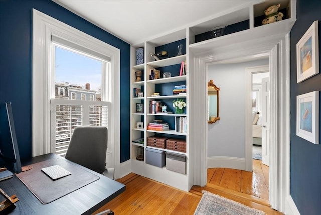 office area featuring baseboards and light wood-style flooring