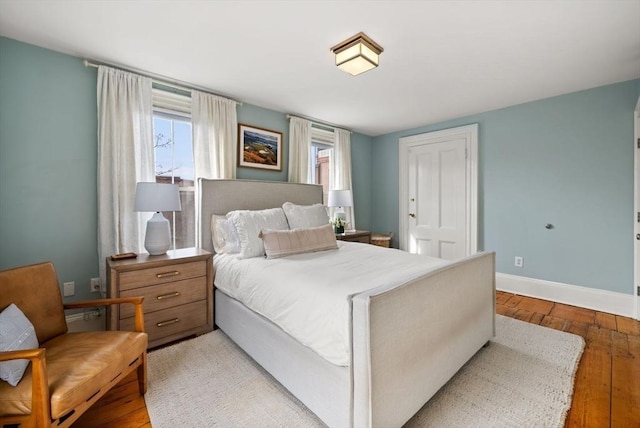 bedroom featuring light wood-style floors and baseboards