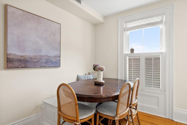 dining space with wood finished floors and baseboards