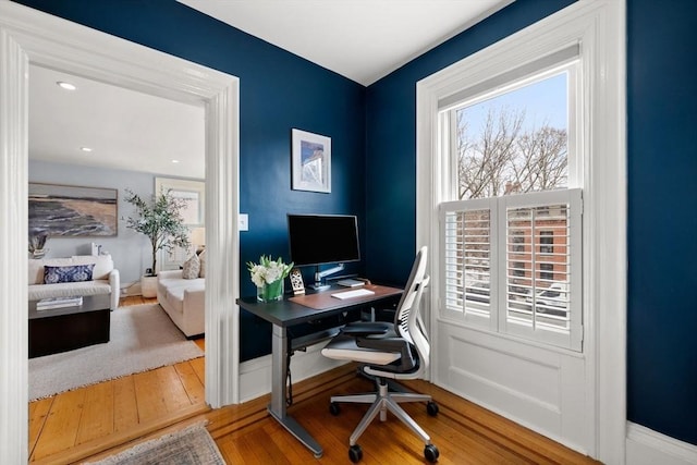 office space with baseboards and wood-type flooring