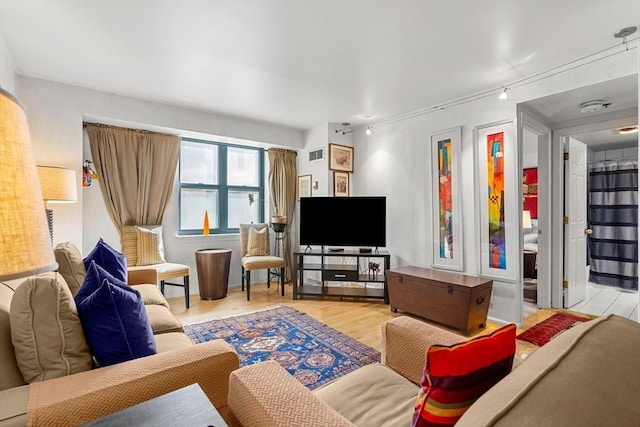 living room featuring wood finished floors and visible vents