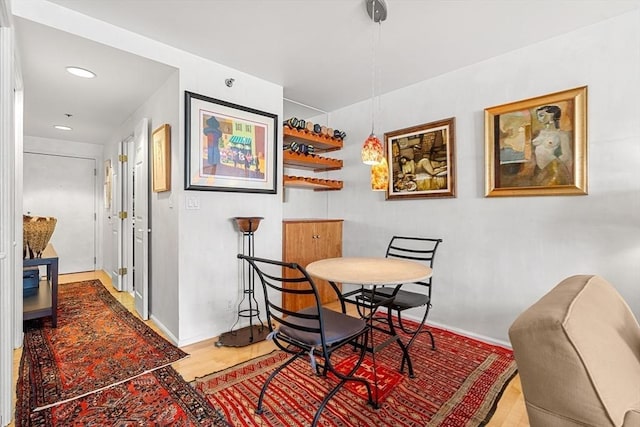 dining area featuring recessed lighting, wood finished floors, and baseboards