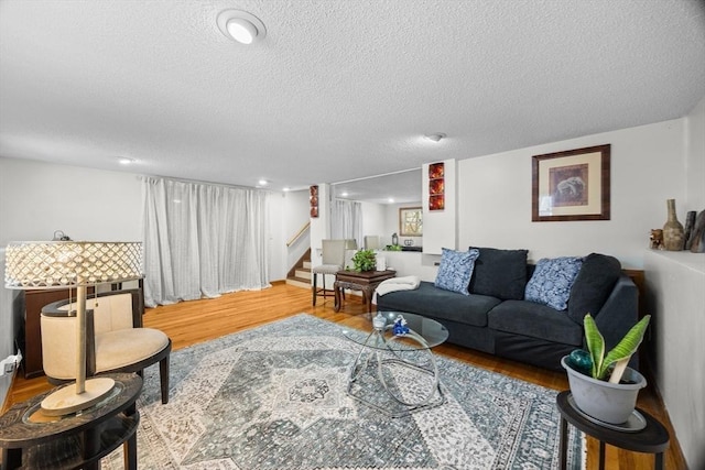 living room featuring light hardwood / wood-style floors and a textured ceiling