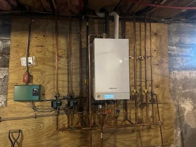 utility room with tankless water heater