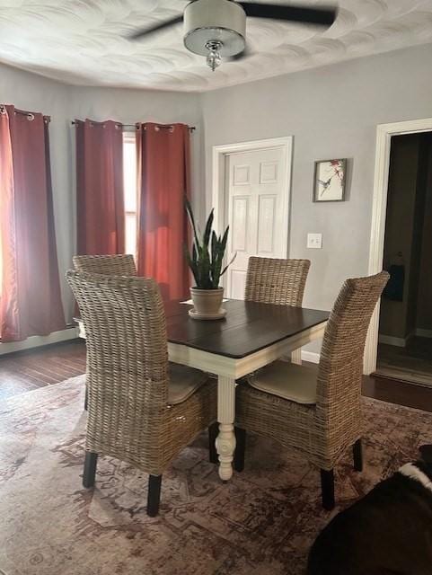 dining area featuring hardwood / wood-style floors and ceiling fan