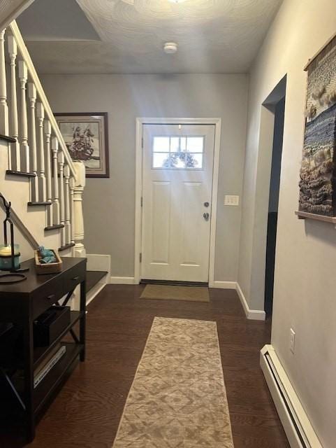 entrance foyer with dark hardwood / wood-style flooring and a baseboard radiator