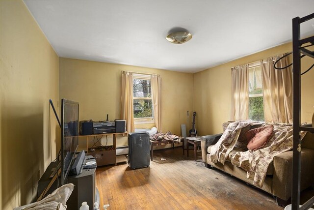 office space with hardwood / wood-style floors and a baseboard heating unit