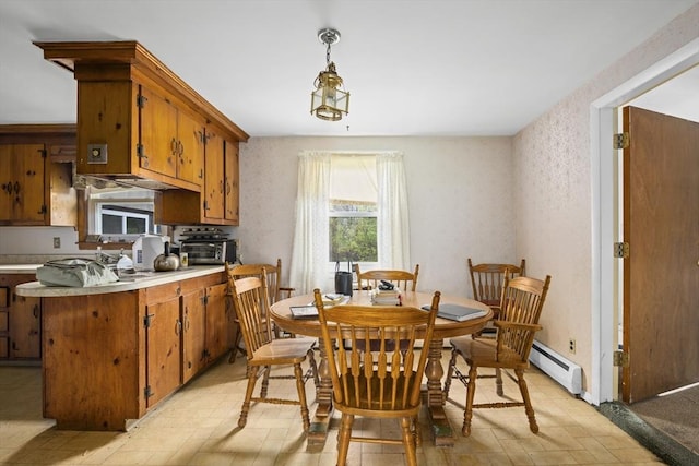 dining space with a baseboard radiator
