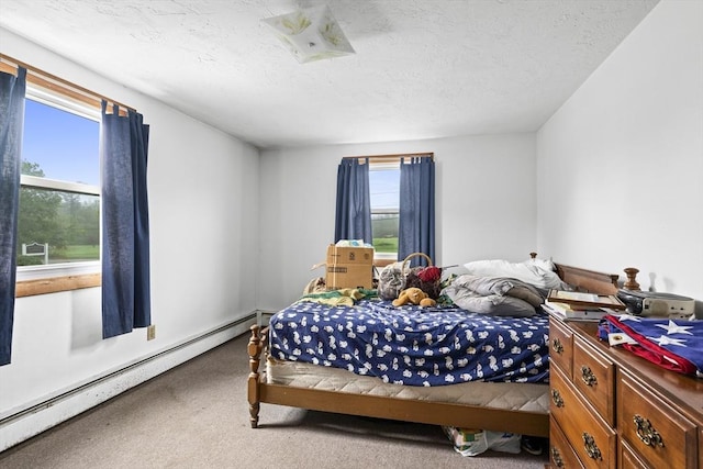 carpeted bedroom featuring baseboard heating and a textured ceiling