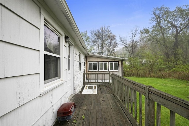 wooden deck featuring a yard