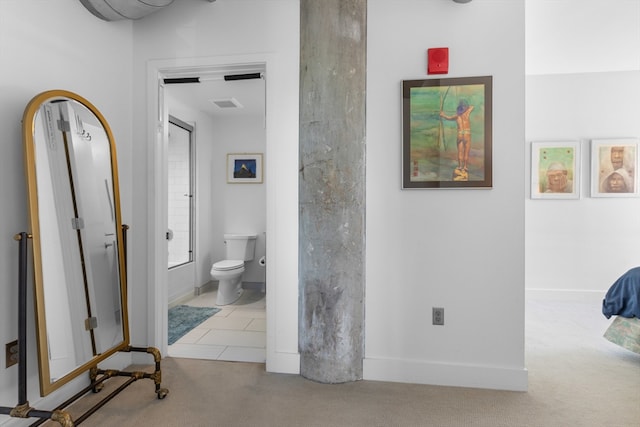 hall featuring visible vents, carpet, and baseboards