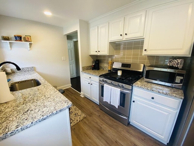 124 Kingston St Unit 124, North Andover, MA 01845 - kitchen featuring appliances with stainless steel finishes, dark wood-style flooring, white cabinetry, backsplash, and open shelves