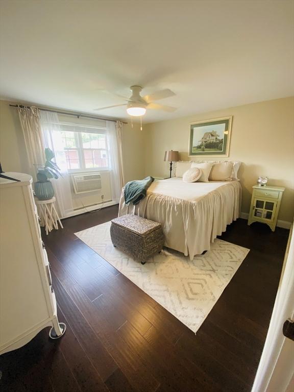 124 Kingston St Unit 124, North Andover, MA 01845 - bedroom with dark wood finished floors, ceiling fan, and cooling unit