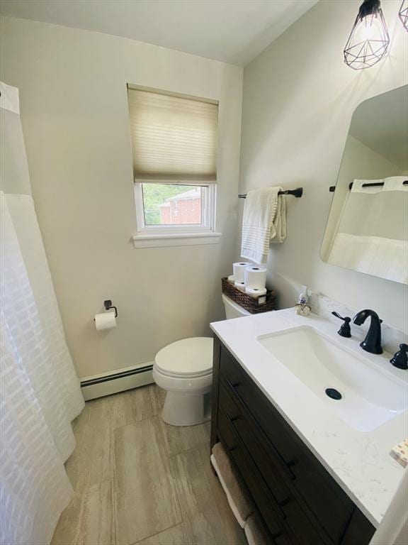 124 Kingston St Unit 124, North Andover, MA 01845 - full bath featuring baseboard heating, vanity, wood finished floors, and curtained shower
