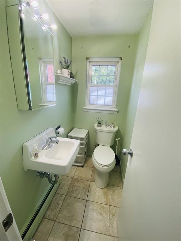 124 Kingston St Unit 124, North Andover, MA 01845 - half bathroom with healthy amount of natural light, tile patterned floors, and baseboard heating