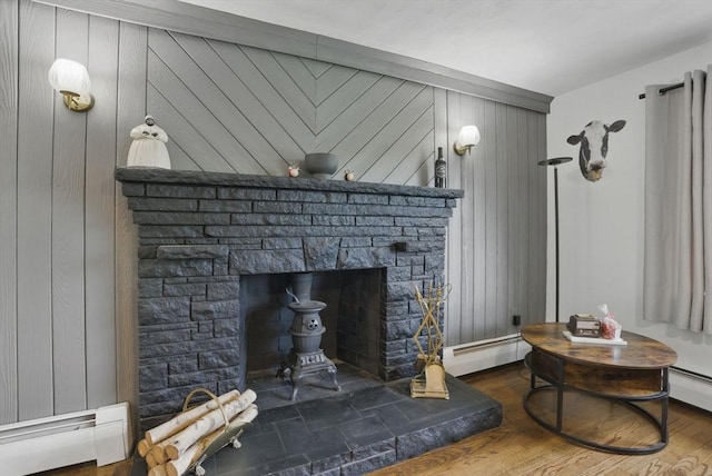 735 Union St, Leominster, MA 01453 - detailed view of baseboard heating, a stone fireplace, wood walls, and a baseboard radiator