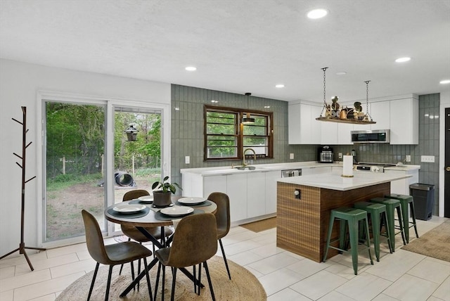 735 Union St, Leominster, MA 01453 - kitchen featuring stainless steel microwave, a kitchen island, modern cabinets, light countertops, and recessed lighting