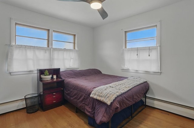 735 Union St, Leominster, MA 01453 - bedroom featuring baseboard heating, wood finished floors, and a ceiling fan
