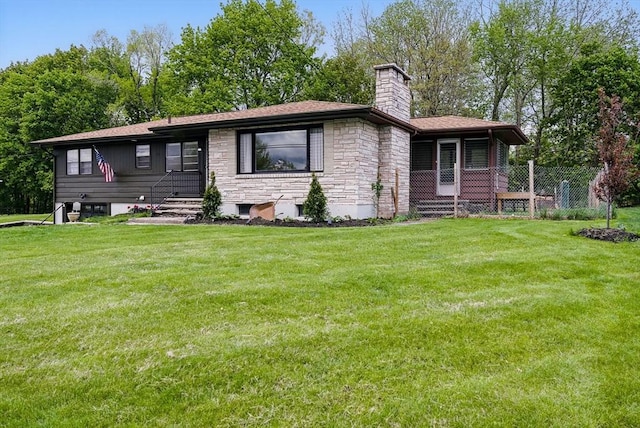735 Union St, Leominster, MA 01453 - view of front facade featuring stone siding, a chimney, and a front lawn