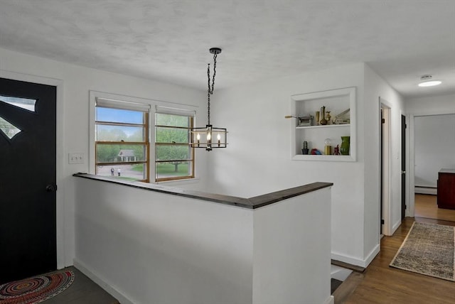 735 Union St, Leominster, MA 01453 - entrance foyer featuring baseboard heating, baseboards, a chandelier, and wood finished floors