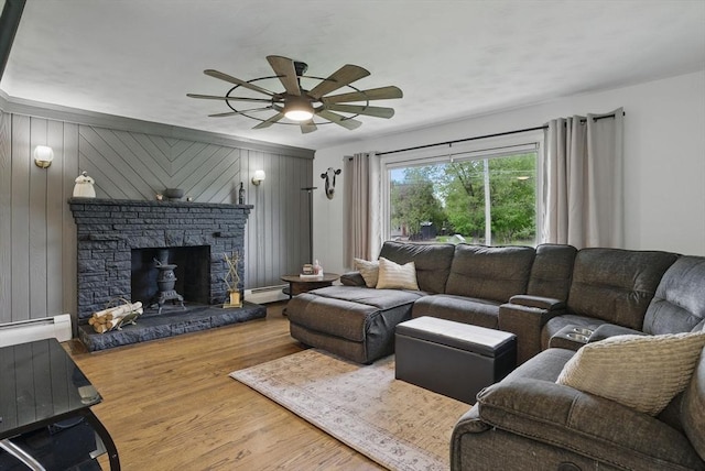 735 Union St, Leominster, MA 01453 - living room featuring a baseboard radiator, ceiling fan, wood finished floors, and a fireplace