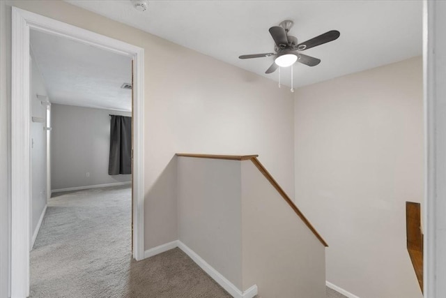stairs featuring carpet, baseboards, and a ceiling fan