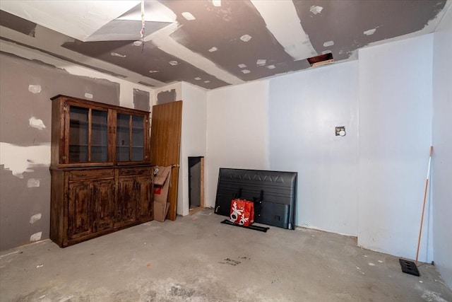 unfurnished living room featuring unfinished concrete flooring