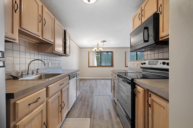 kitchen with range with electric cooktop, black microwave, a sink, baseboards, and stainless steel dishwasher