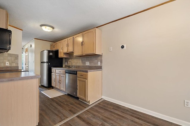 kitchen featuring stainless steel appliances, light brown cabinets, tasteful backsplash, dark wood-type flooring, and crown molding